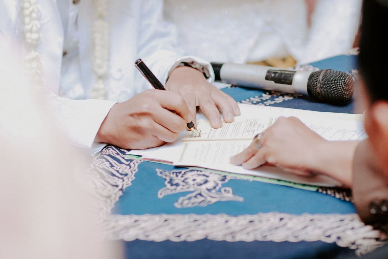 Wedding rings resting on paperwork