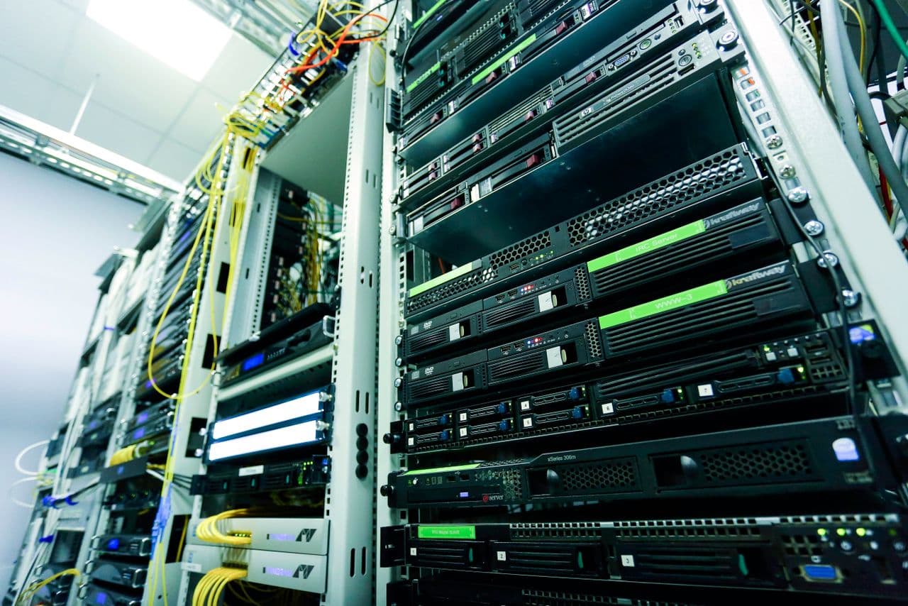 A padlock over server racks representing data security