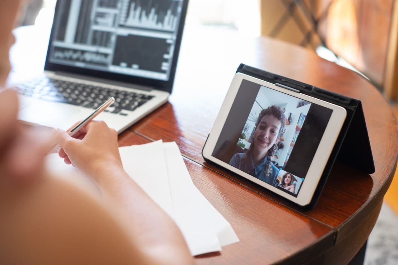 Working remotely from a home desk on a video call