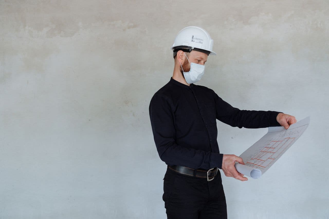 A structural engineer reviewing plans on a construction site